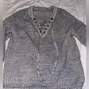 gray sweater with cross up on chest